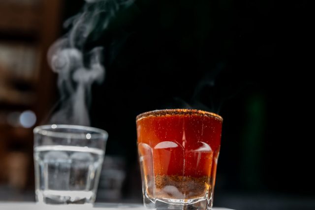 a freshly poured cup of coffee in the sunlight on a dark background